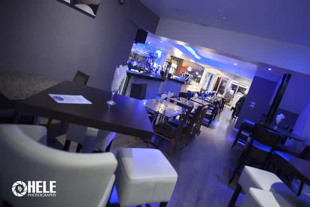 Modern Santorini restaurant venue with sleek furniture, ideal for events and gatherings.