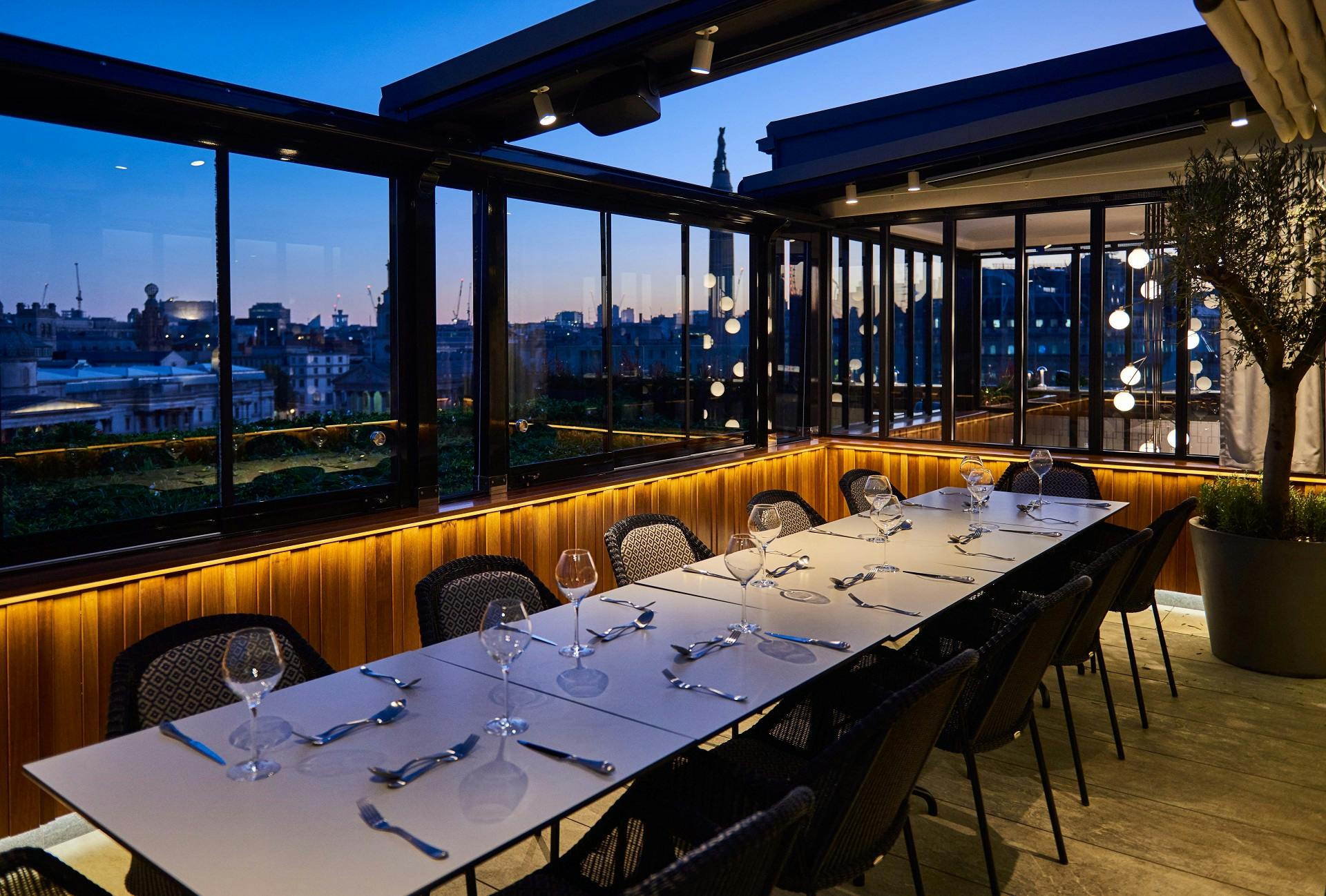 Stylish rooftop event space with panoramic city views for dinners and gatherings. - Banner