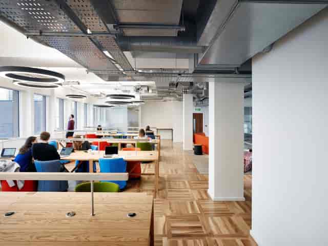 Modern open-plan co-working space with colorful seating for collaborative meetings and events.