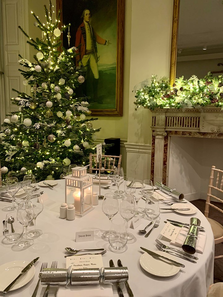 Elegant Christmas dining table with tree and fireplace at 41 Portland Place. Holiday event.