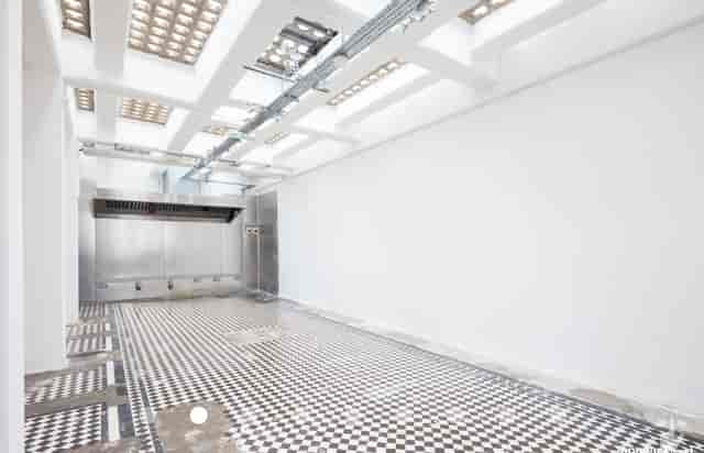 Versatile event space in Abracadabra Hub with polished checkered floor for corporate meetings.