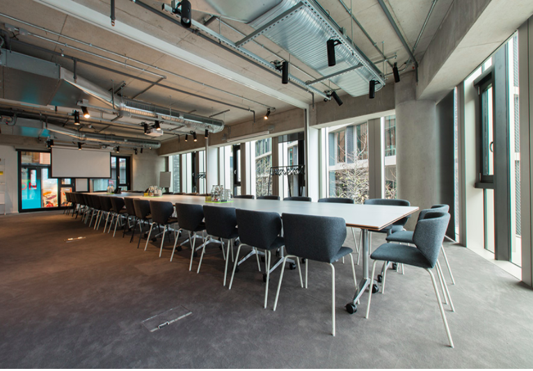 Industrial-chic boardroom, long table, ideal for strategy sessions and professional meetings.