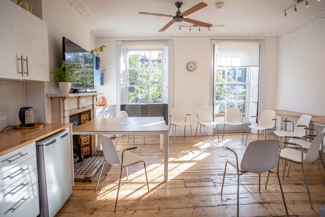 Bright meeting space with large windows, ideal for workshops and team gatherings.