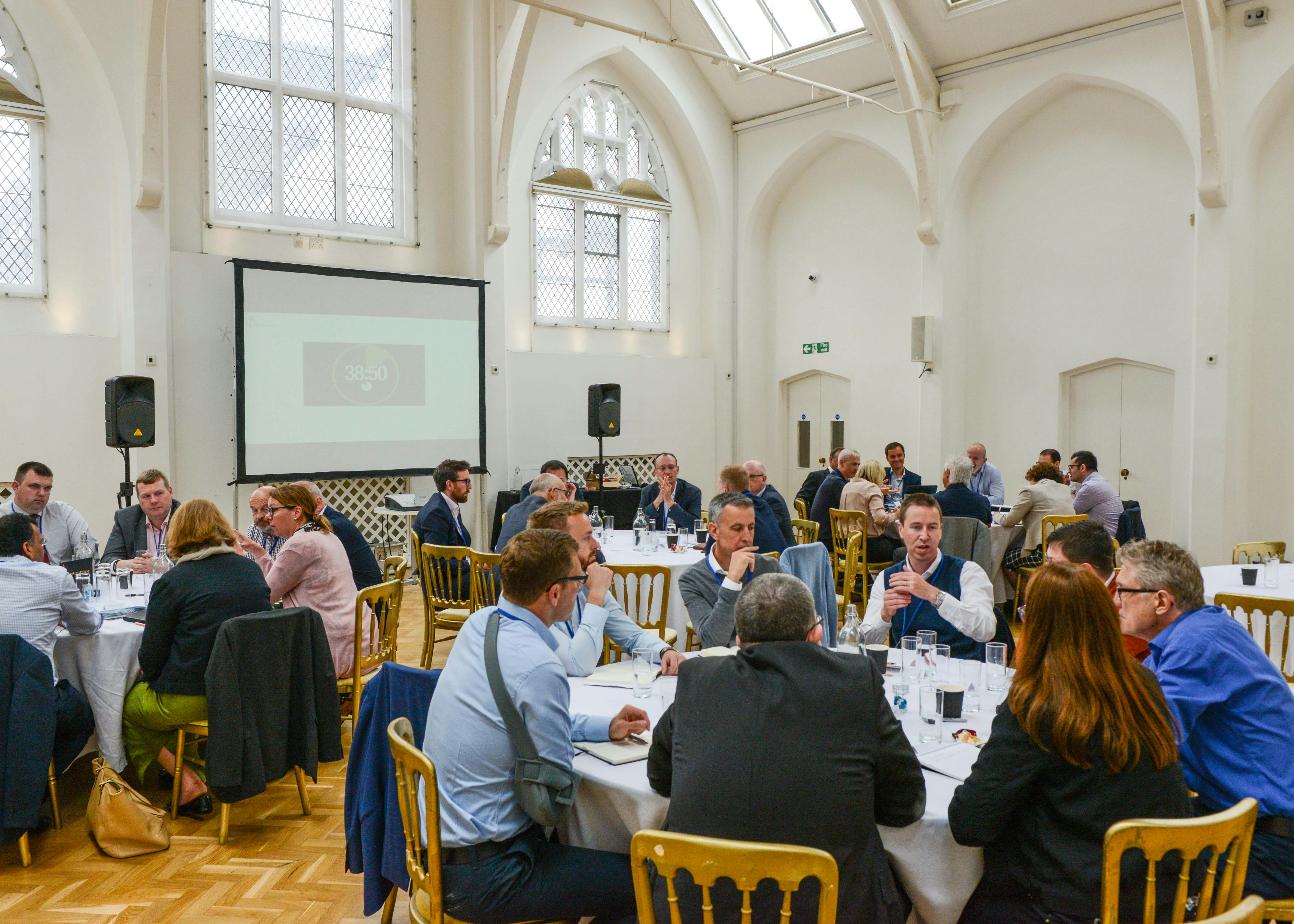 Exclusive Hire in The Old Library: bright meeting setup with round tables for collaboration.