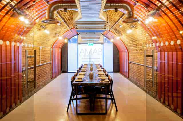 Private meeting room with exposed brick walls, ideal for workshops and presentations.