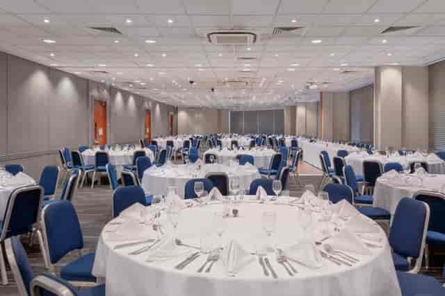 Banquet hall at Holiday Inn Kensington, set for corporate event with elegant table settings.