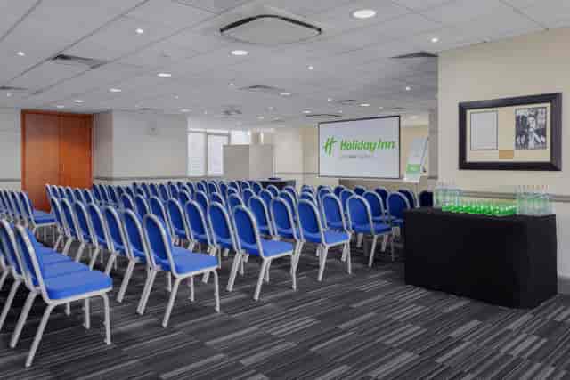 Meeting space with blue chairs at Holiday Inn London Kensington for conferences.