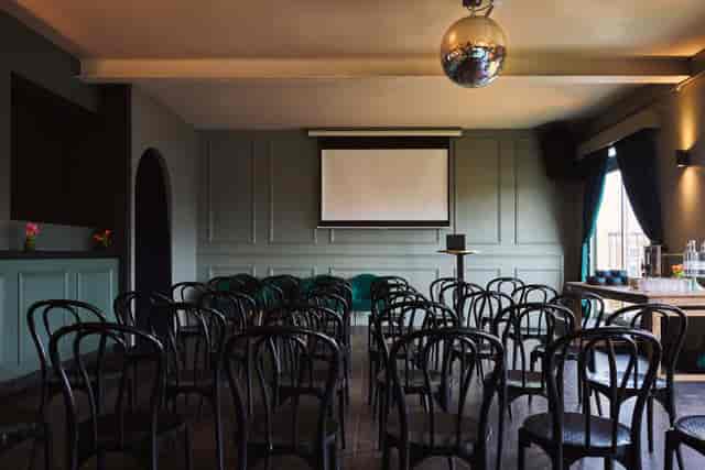 Theater-style event space at The Exhibit Balham with AV setup for workshops and presentations.