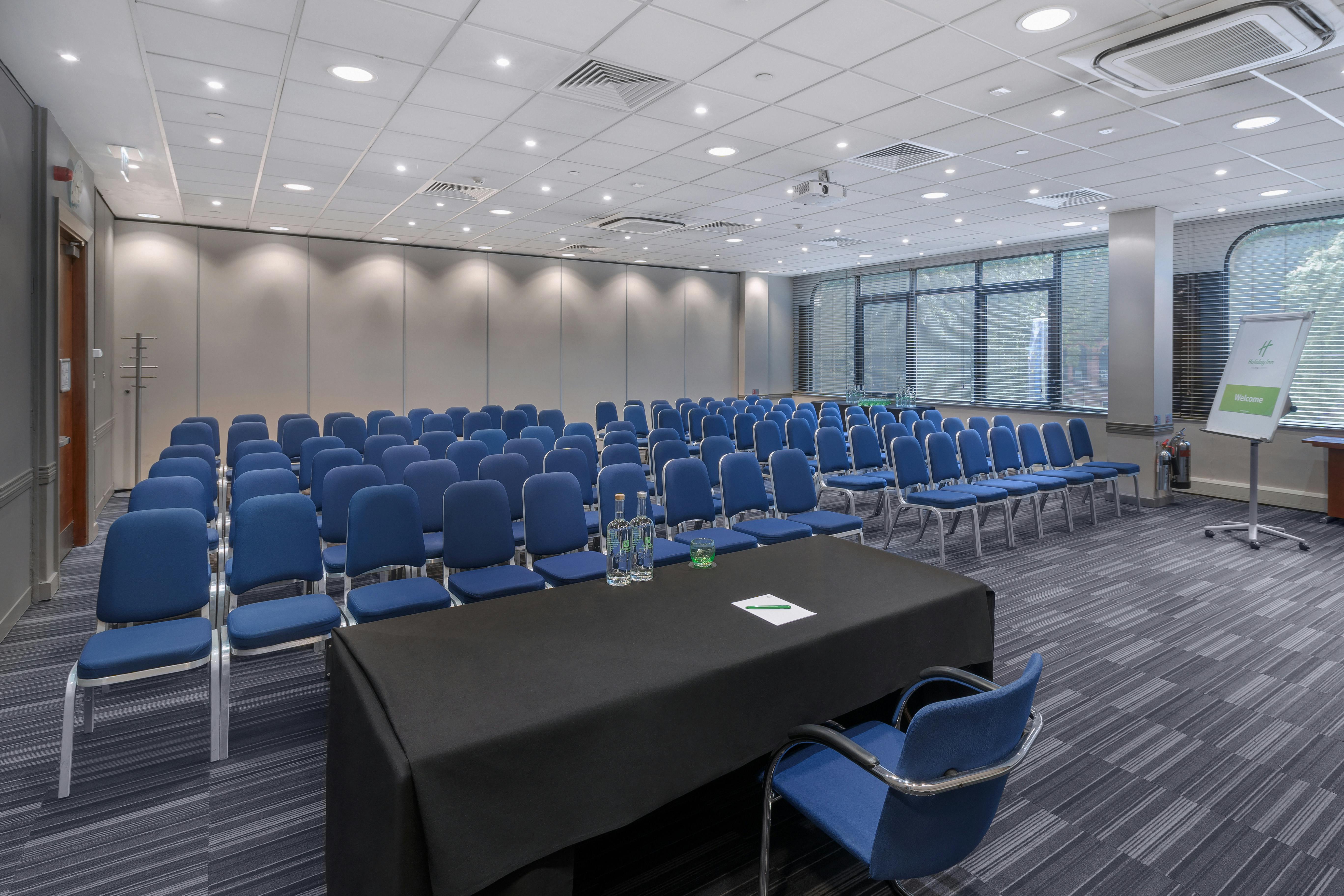 Dylan in a bright meeting room at Holiday Inn Kensington for a seminar event.