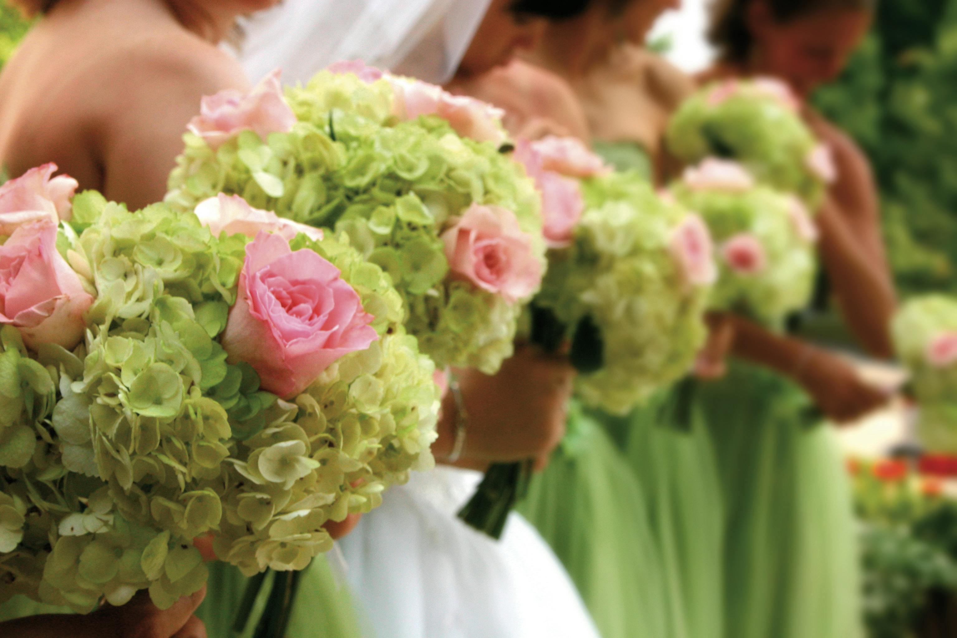 Bridal party with pink roses at Holiday Inn London Kensington Forum event.