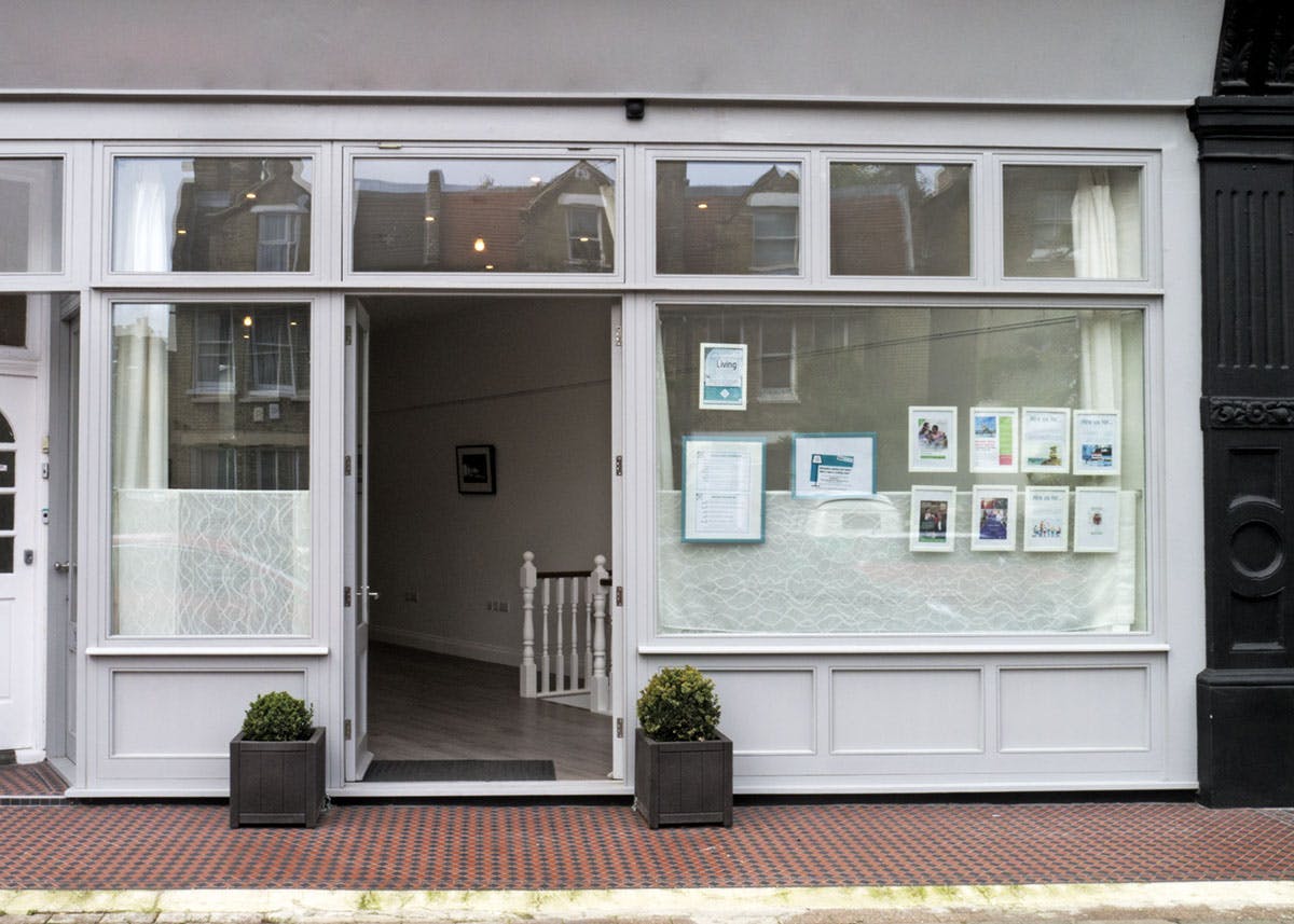 Versatile event space with large windows at The Living Room Place, ideal for gatherings.
