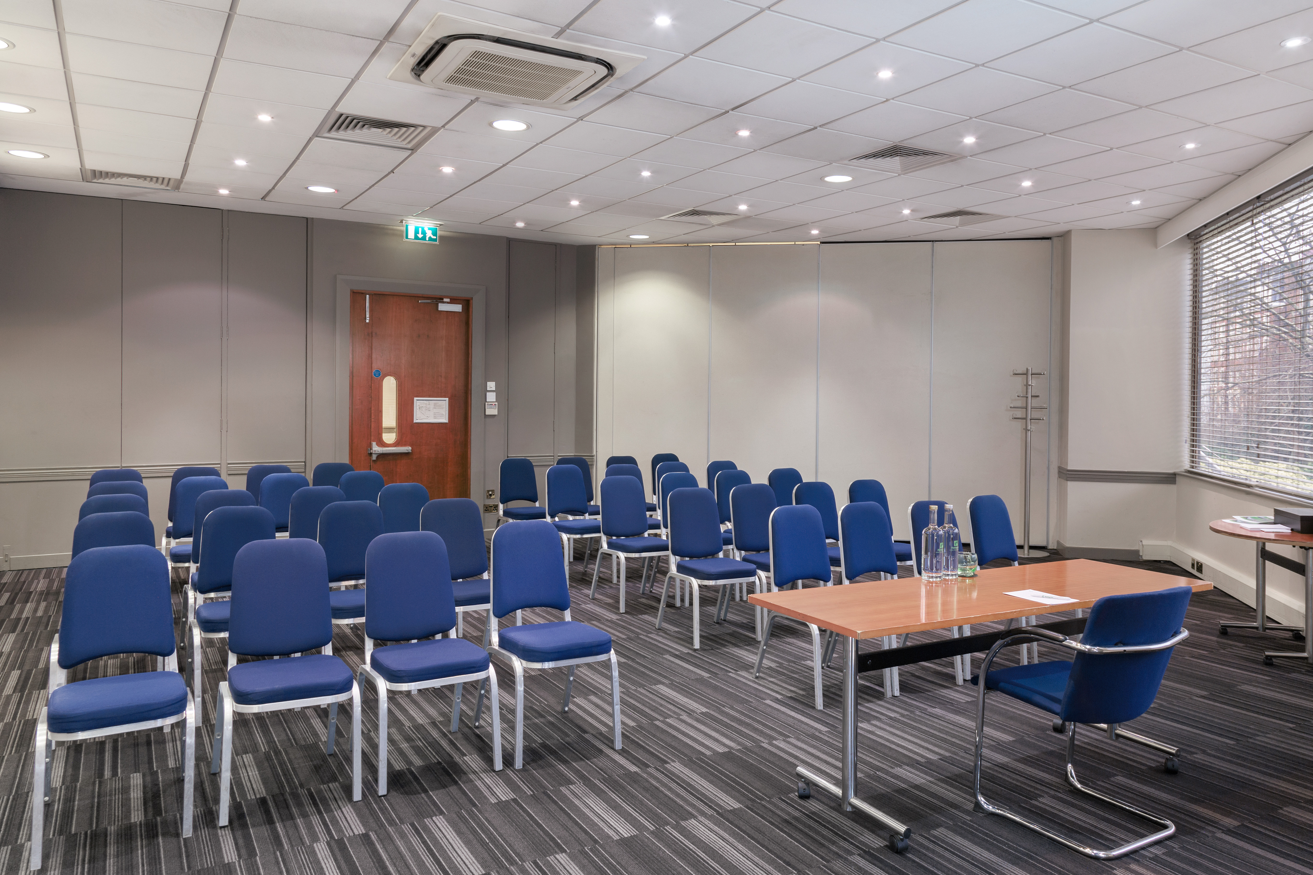 Madonna in a professional meeting room setup for a workshop at Holiday Inn Kensington.