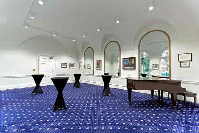 Elegant event space with grand piano, ideal for networking and receptions at Imperial Venues.