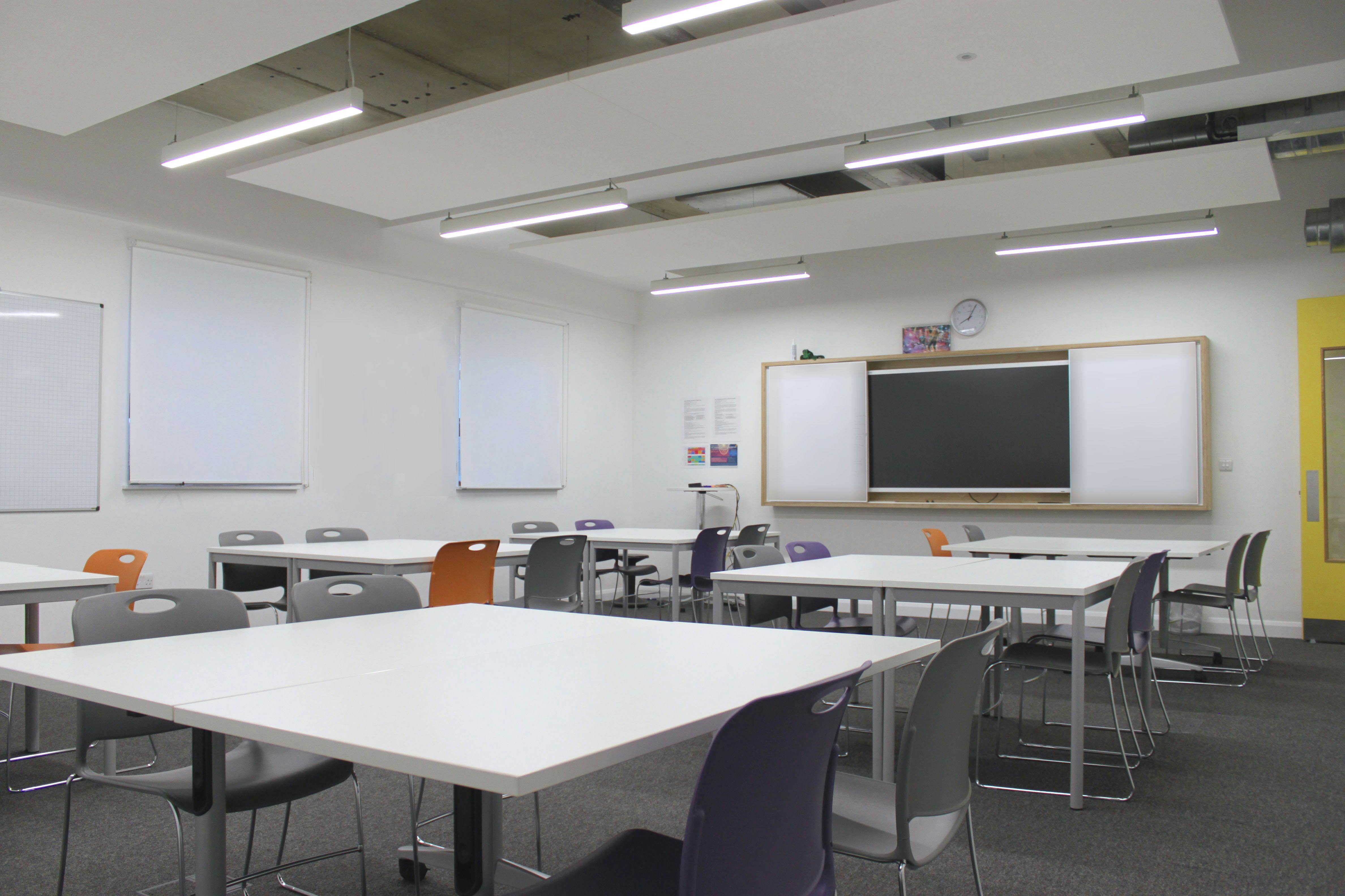 Modern classroom with flexible seating for training sessions and workshops at Ada National College.