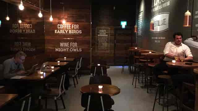 Cozy Back Space venue with warm lighting for informal meetings and networking events.