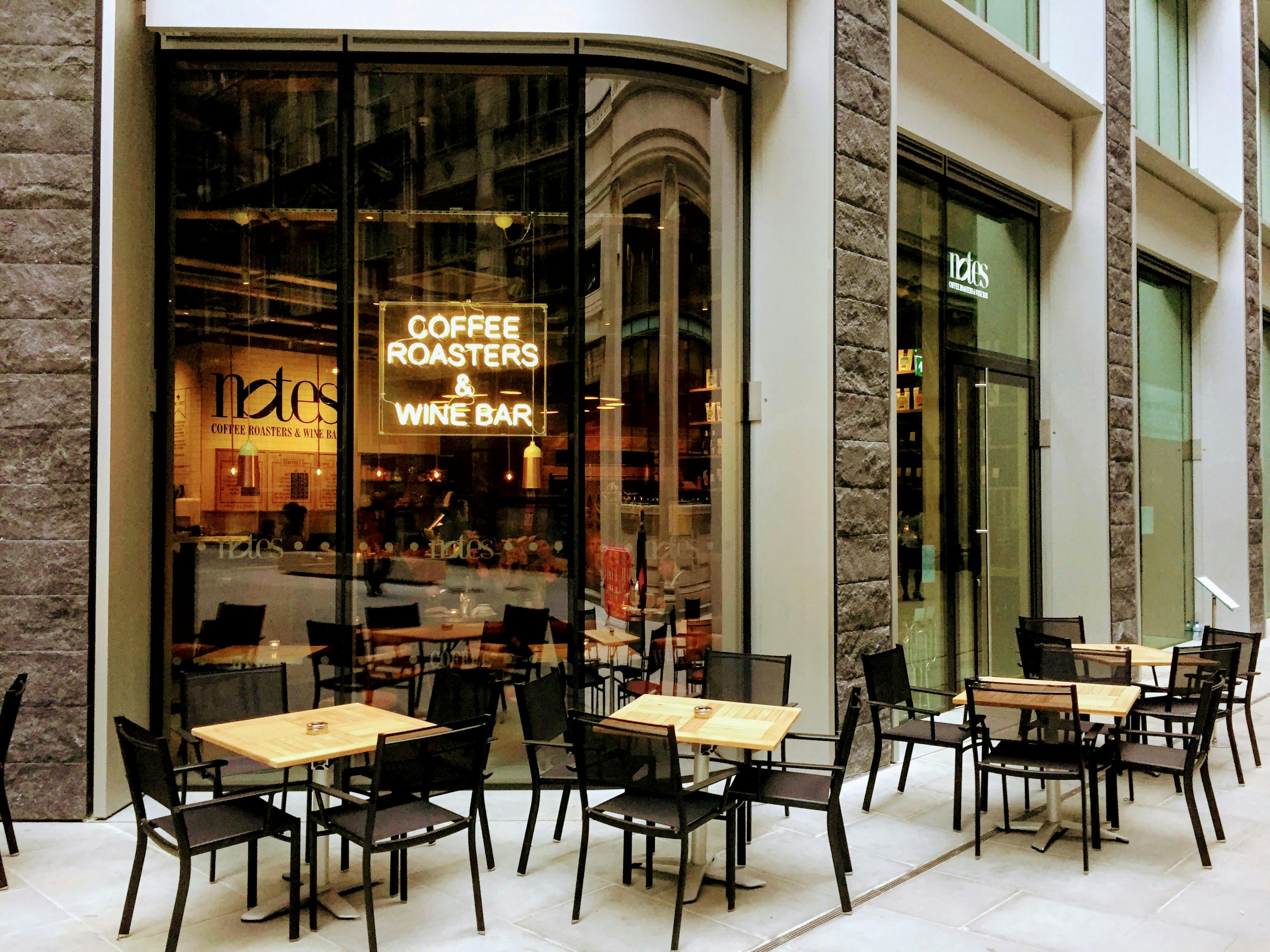 Stylish outdoor seating at Notes Bank coffee roasters for casual meetings and networking.