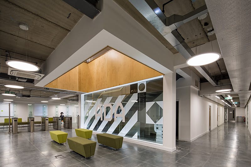 Modern glass pod lobby at Ada National College, ideal for meetings and events.