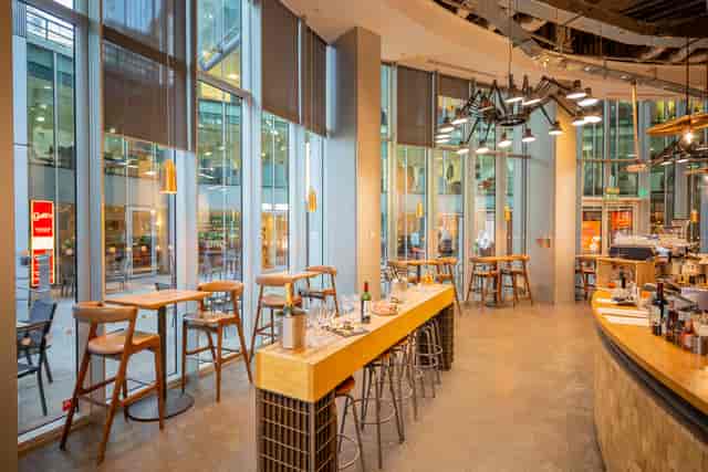 Modern open-concept venue with large windows for networking events and casual meetings.