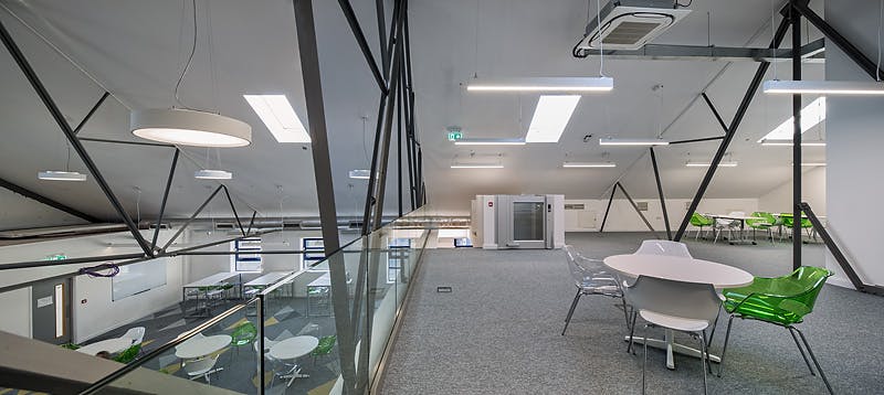 Modern meeting space with glass railings at Ada National College for Digital Skills events.