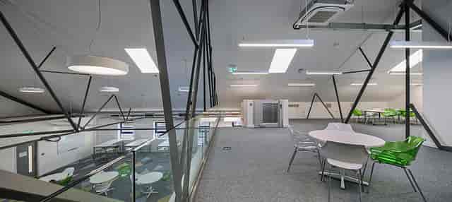 Modern meeting space with glass railings at Ada National College for Digital Skills events.