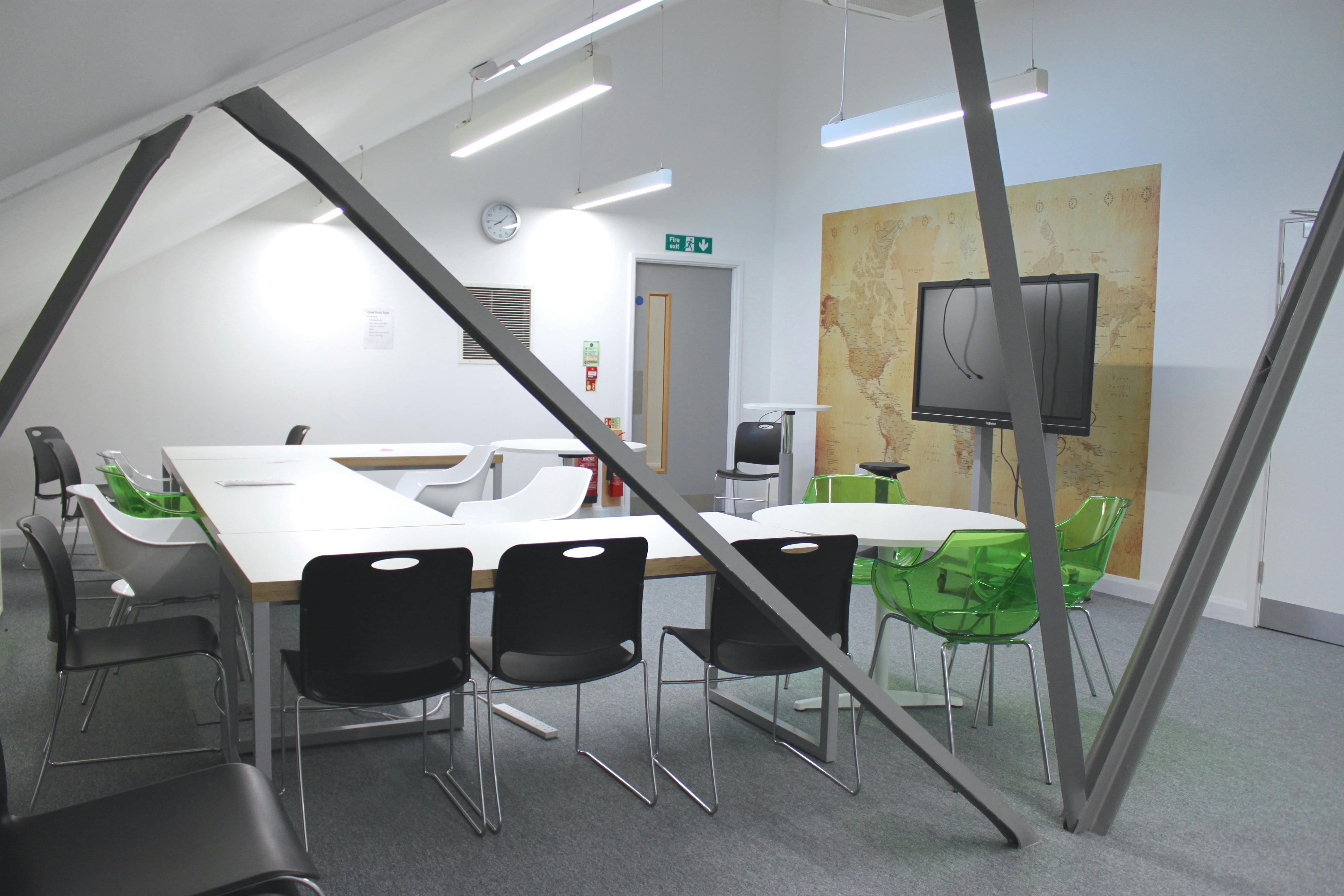 Modern meeting space with large table and ergonomic chairs at Ada National College.