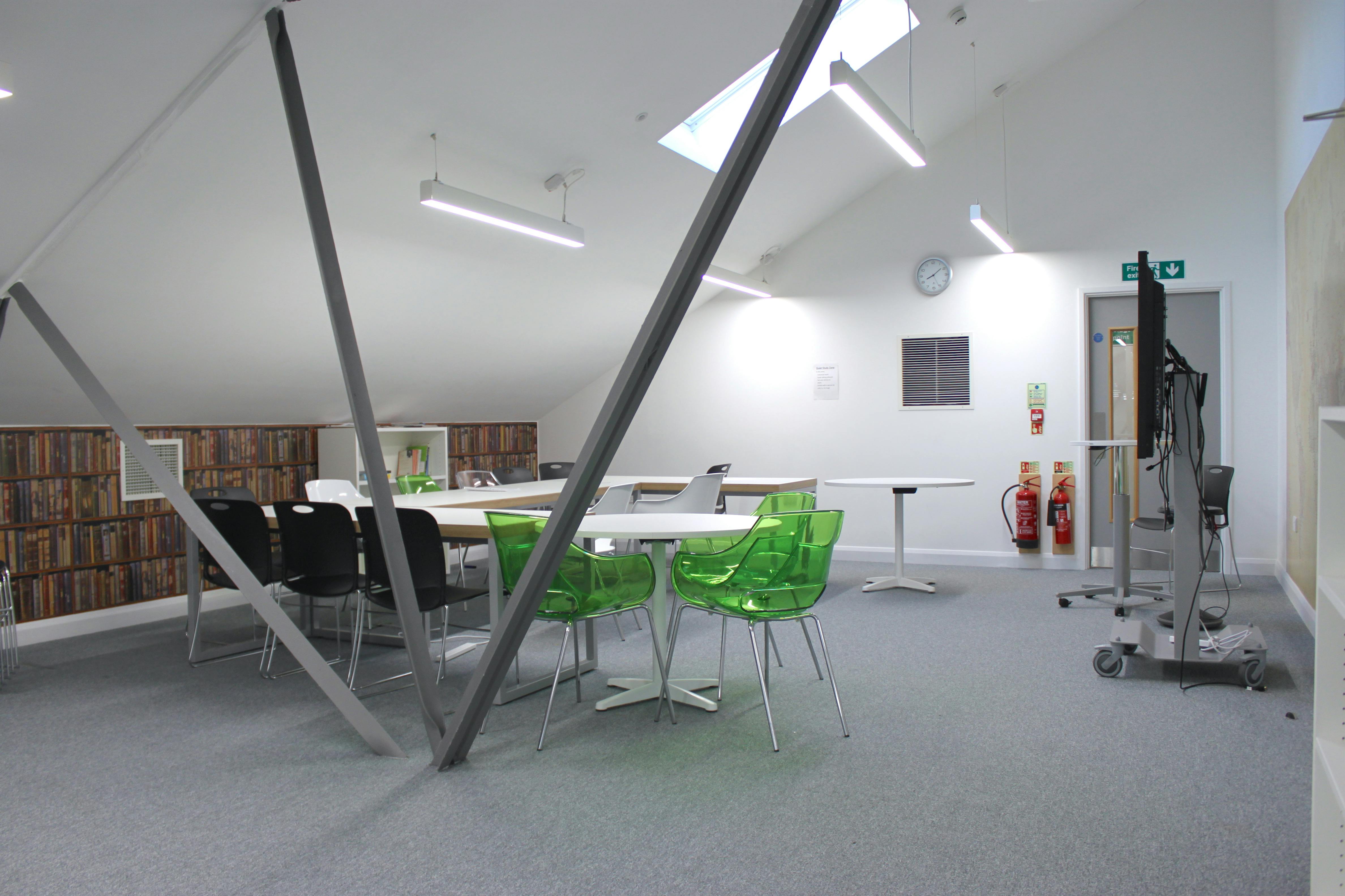 Modern meeting space with vibrant green chairs at Ada National College for workshops.