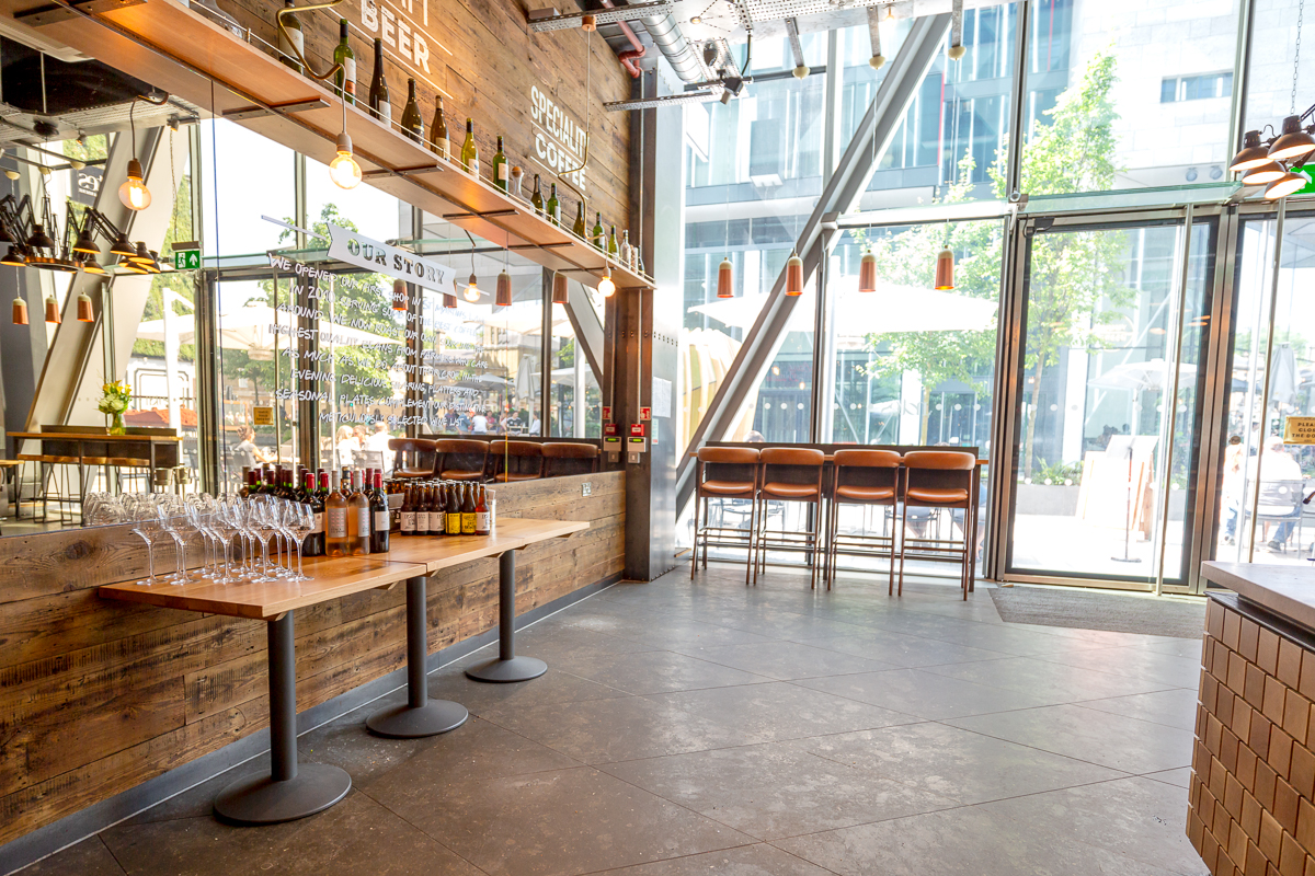 Modern event space in Notes Victoria with stylish bar, ideal for receptions and gatherings. - Banner