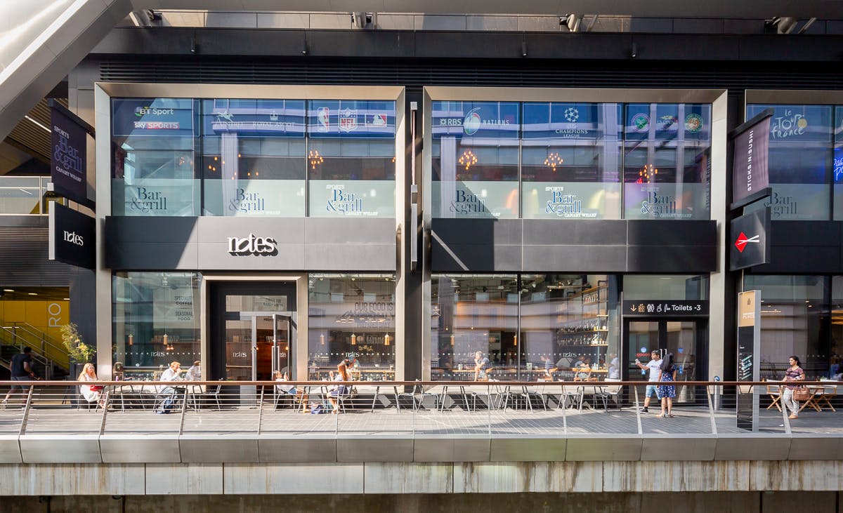 Modern event venue with large glass windows at Everyman Canary Wharf, ideal for gatherings.