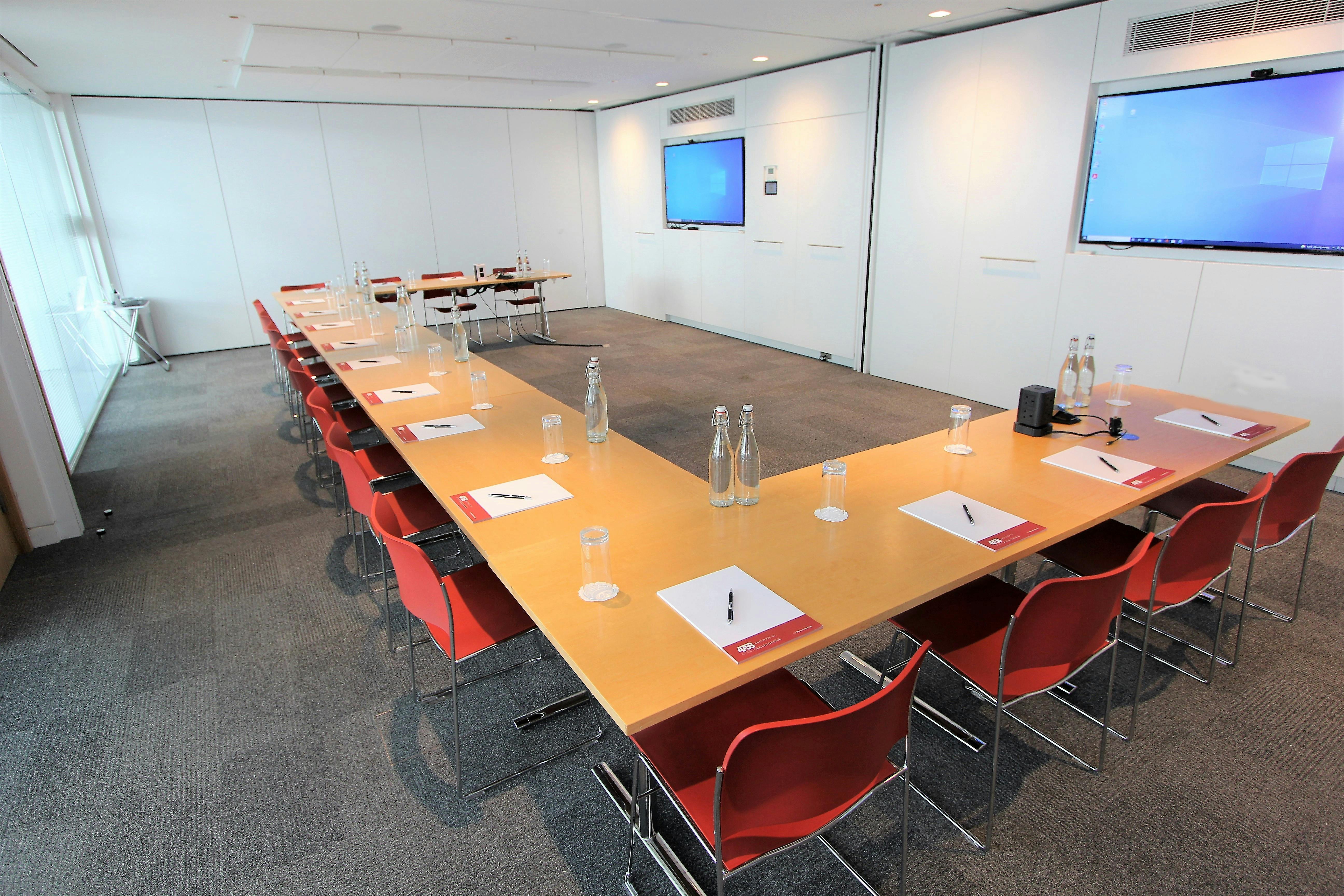 Modern meeting room with U-shaped table for collaborative events at Belgrave Suite.