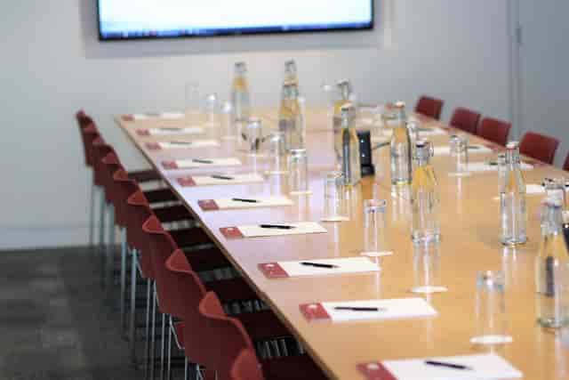 Bastwick Suite meeting room with long table, notepads, and presentation screen.