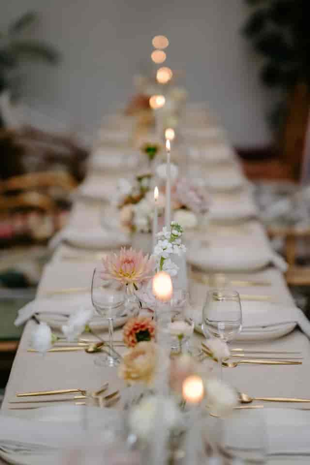 Elegant dining table with floral arrangements for upscale events in Greenhouse venue.