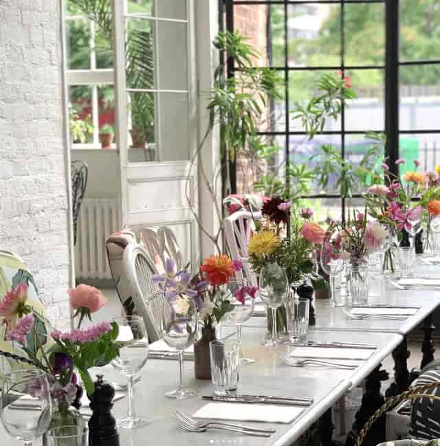 Elegant dining setup with floral centerpieces in Bourne & Hollingsworth for intimate events.