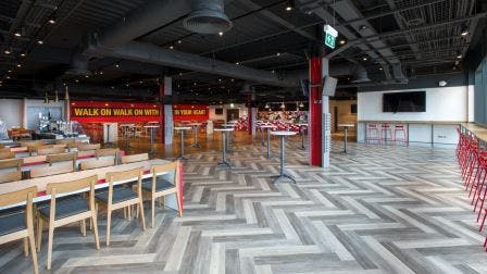 Modern event space at Anfield Beat, featuring herringbone flooring for meetings and gatherings.