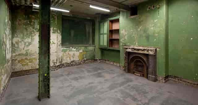 Raw event space with peeling green paint in Shoreditch Town Hall for unique gatherings.