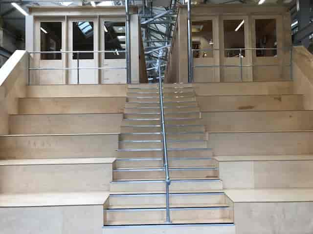 Modern Exhibition Hall in Craft Central with wooden steps for creative events.