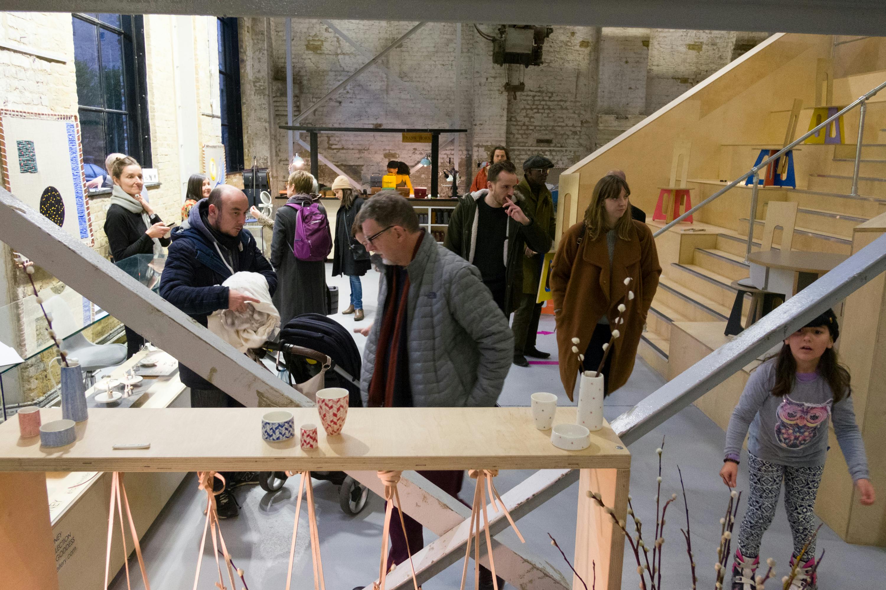 Vibrant Craft Central exhibition hall bustling with attendees for networking event.