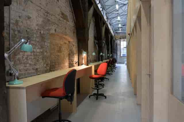 Multipurpose meeting rooms in Craft Central with ergonomic workstations for creative events.