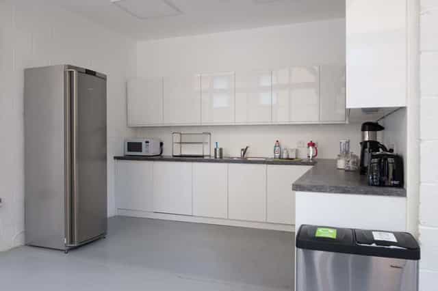 Multipurpose meeting room kitchen with sleek design for events and catering.