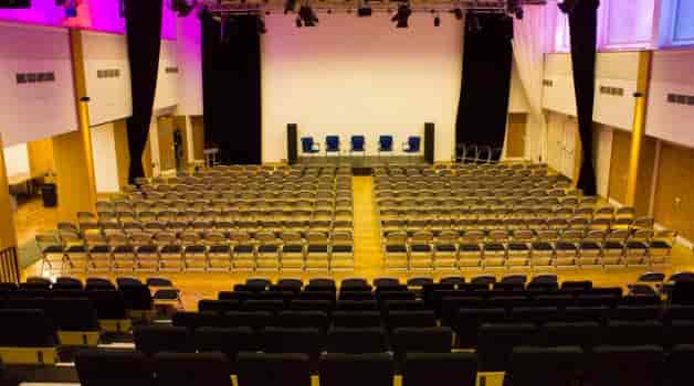 Queen's Park Community School auditorium, theater seating for corporate events and panel discussions.
