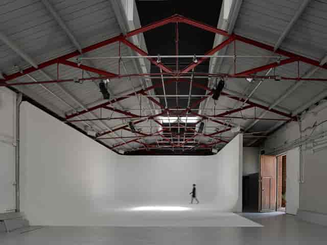 Versatile event space in Park Village with minimalist design and natural light for corporate meetings.