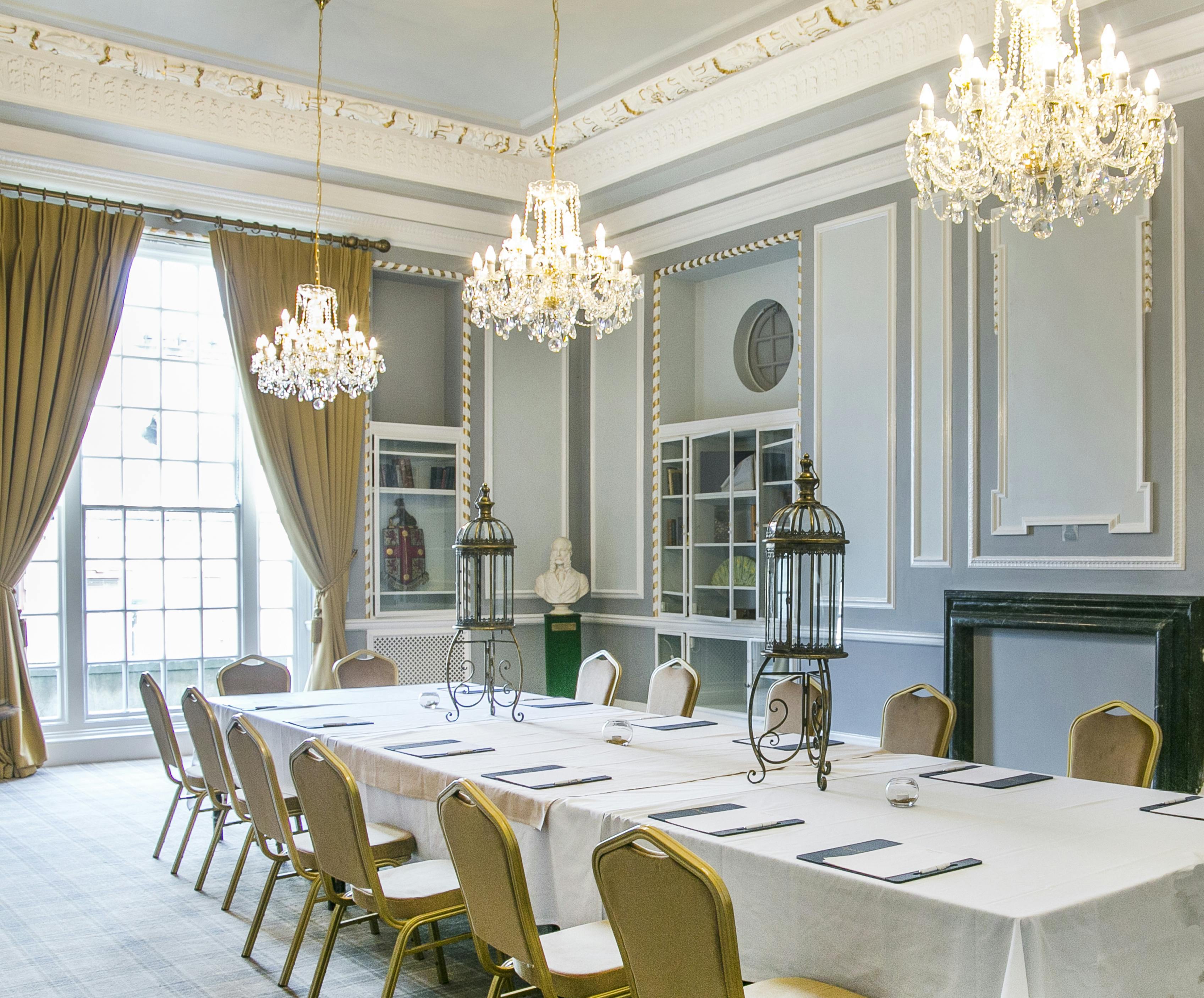 Elegant meeting room in Manchester Hall with chandeliers, ideal for formal events.