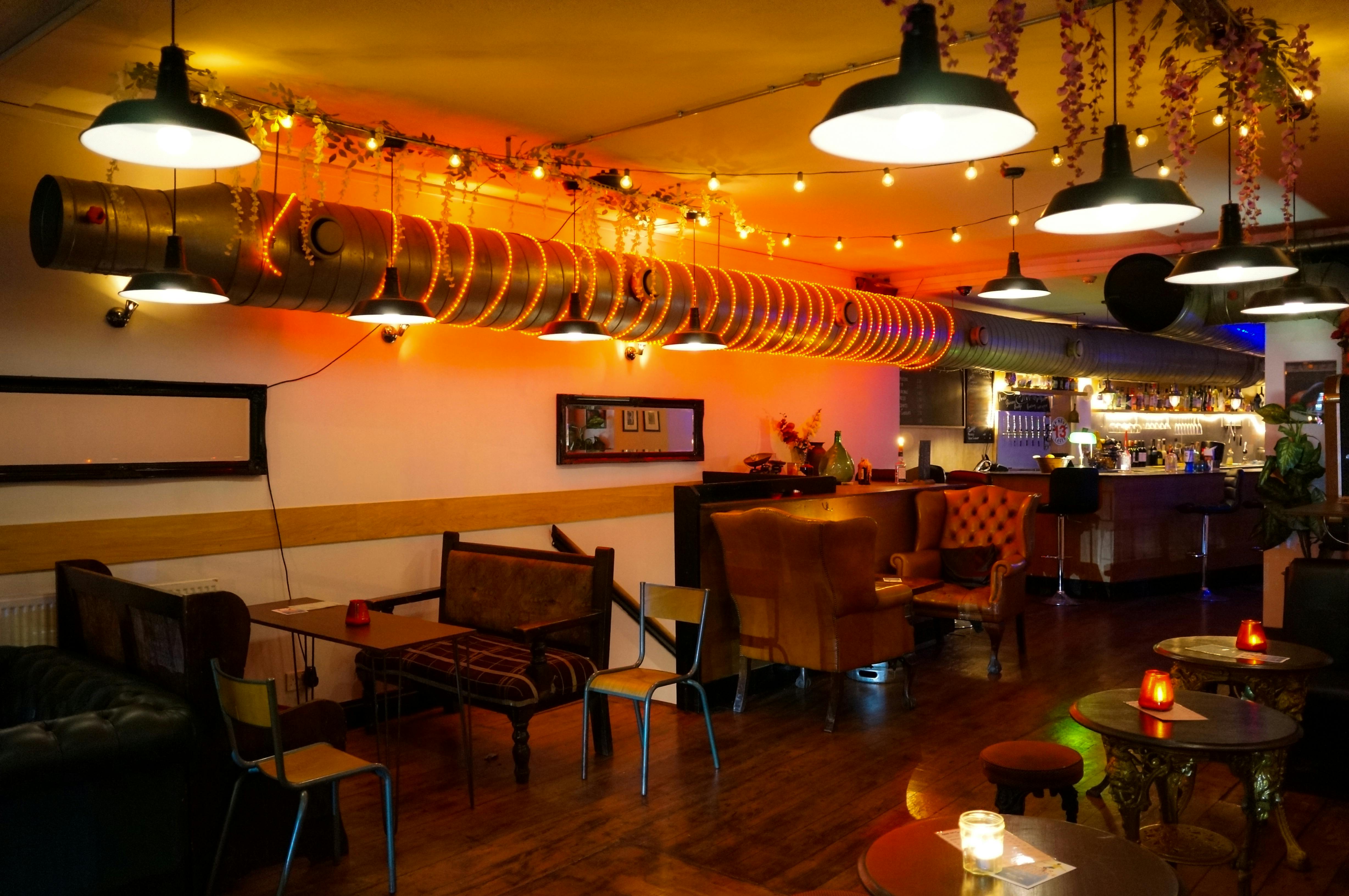 Stylish Main Bar in T-Bird with warm lighting, perfect for casual gatherings and networking.