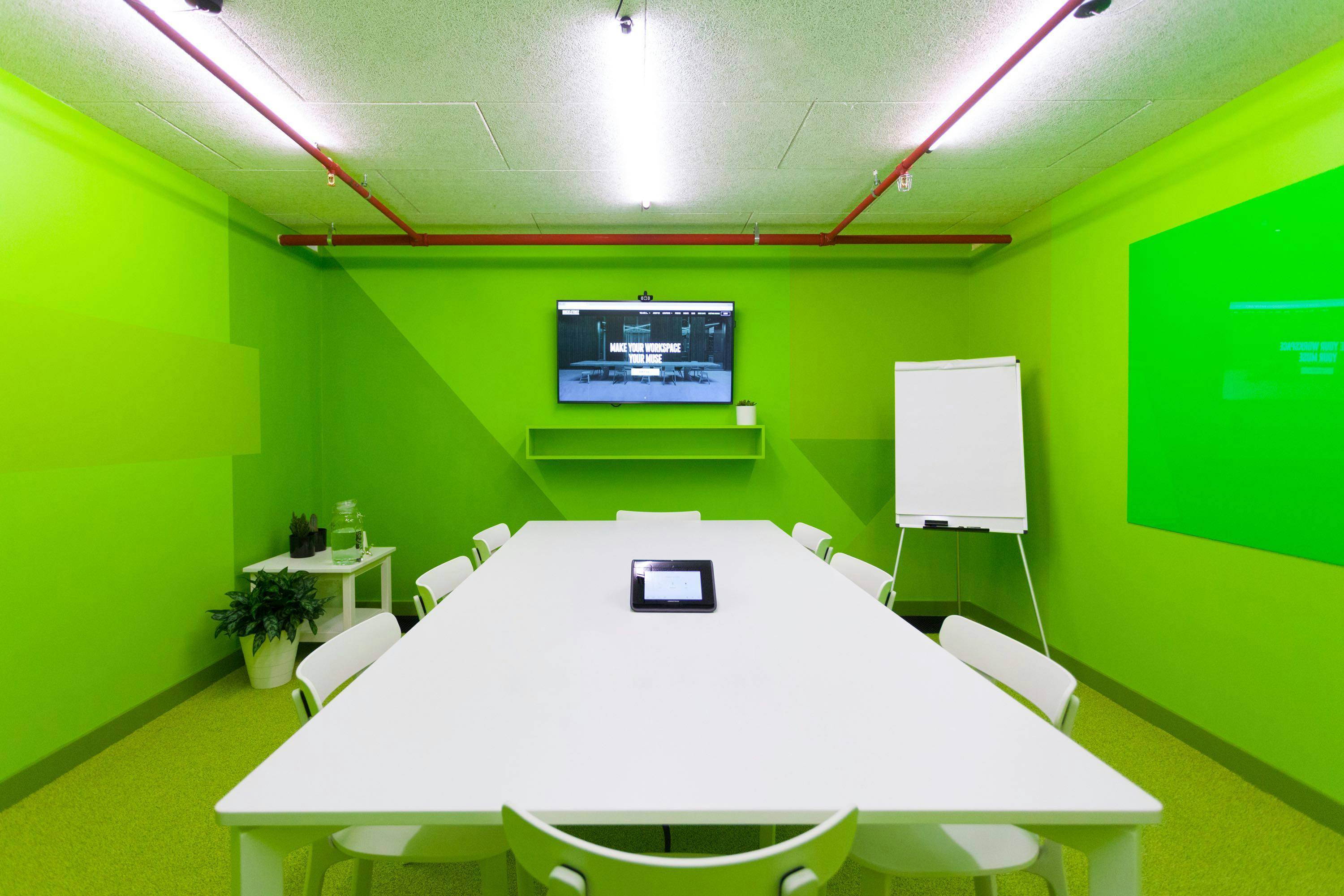 Modern Black Rock Meeting Room with vibrant green decor for collaborative team meetings.