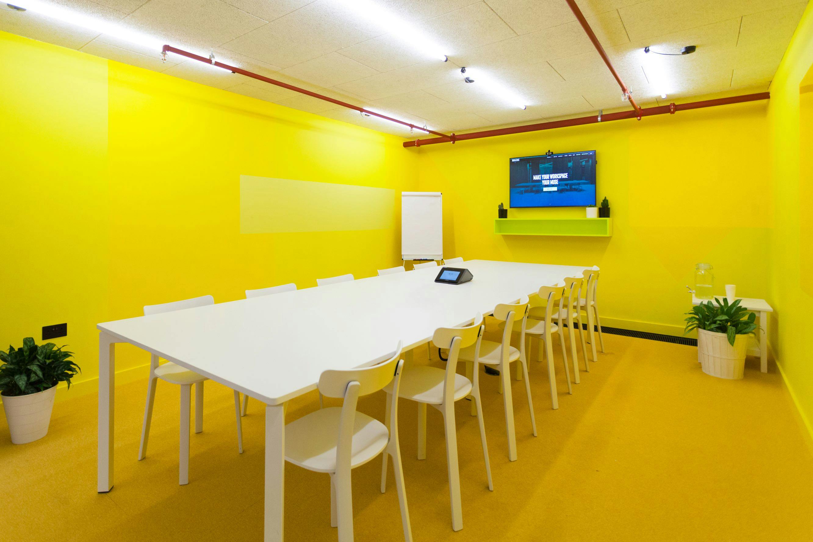 Vibrant Spaceport Meeting Room with yellow walls for creative workshops and brainstorming.