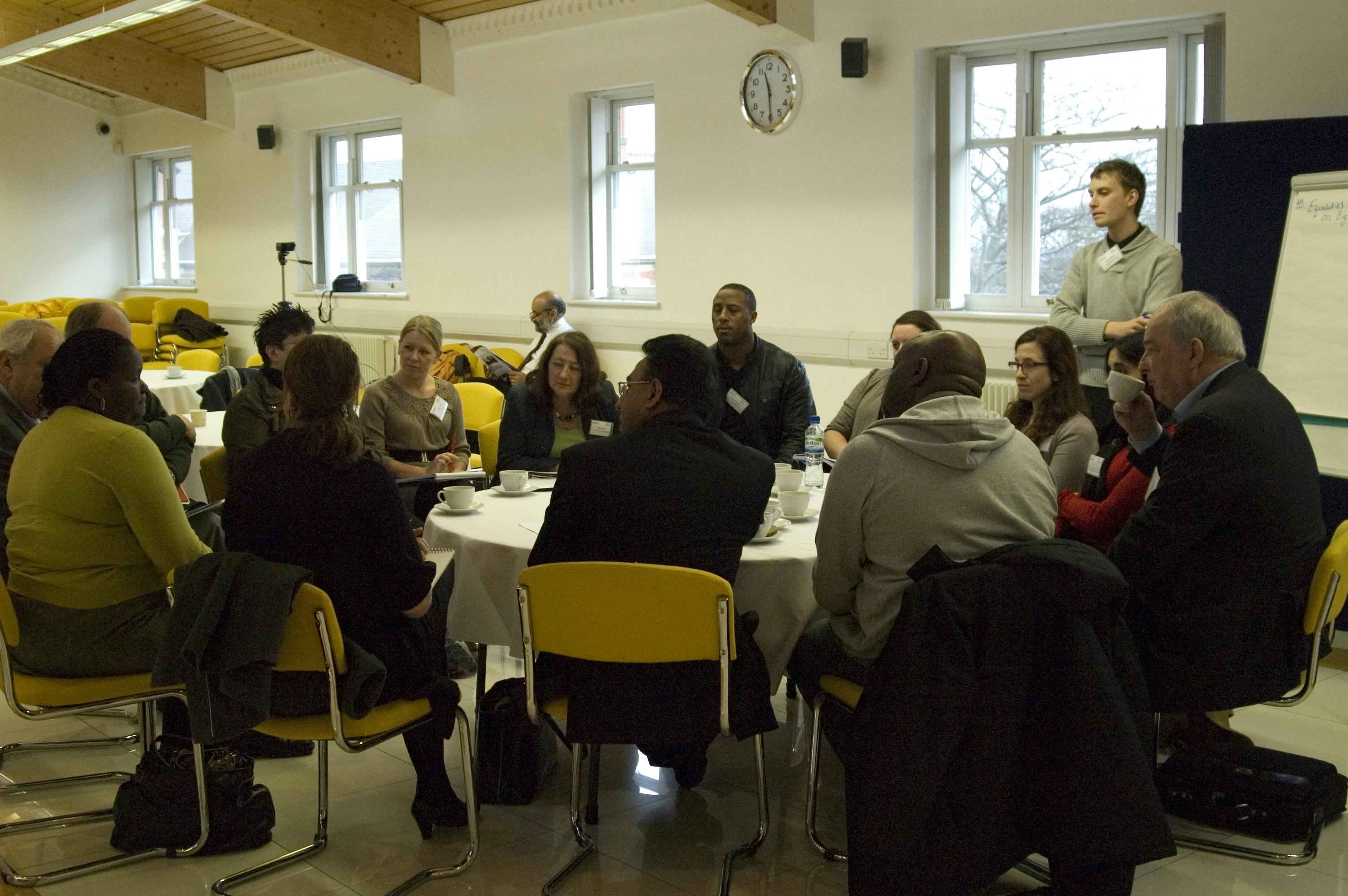 Diverse group in Nishkam Centre conference hall, promoting collaboration and engagement.