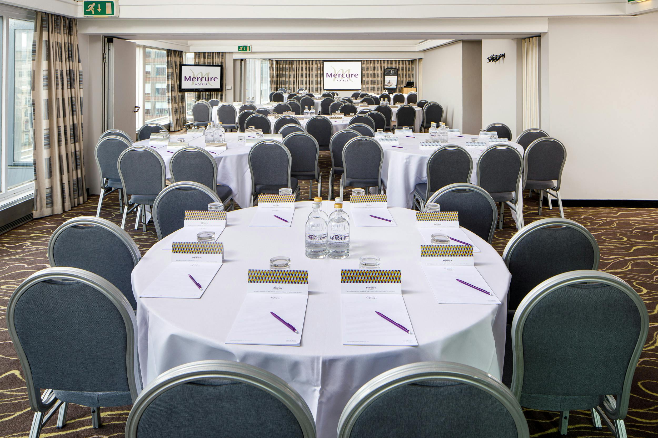 Park Suite at Mercure Manchester: modern meeting space with round tables for professional events.