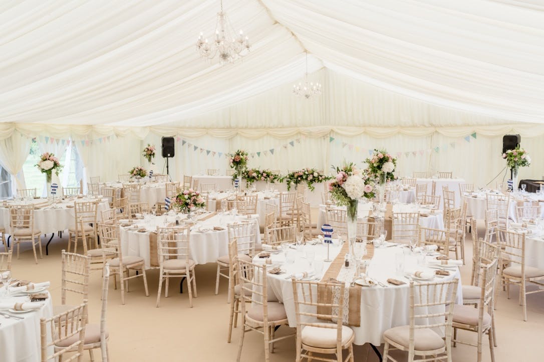 Elegant marquee at Roundoak Farm for weddings and corporate events with floral centerpieces.