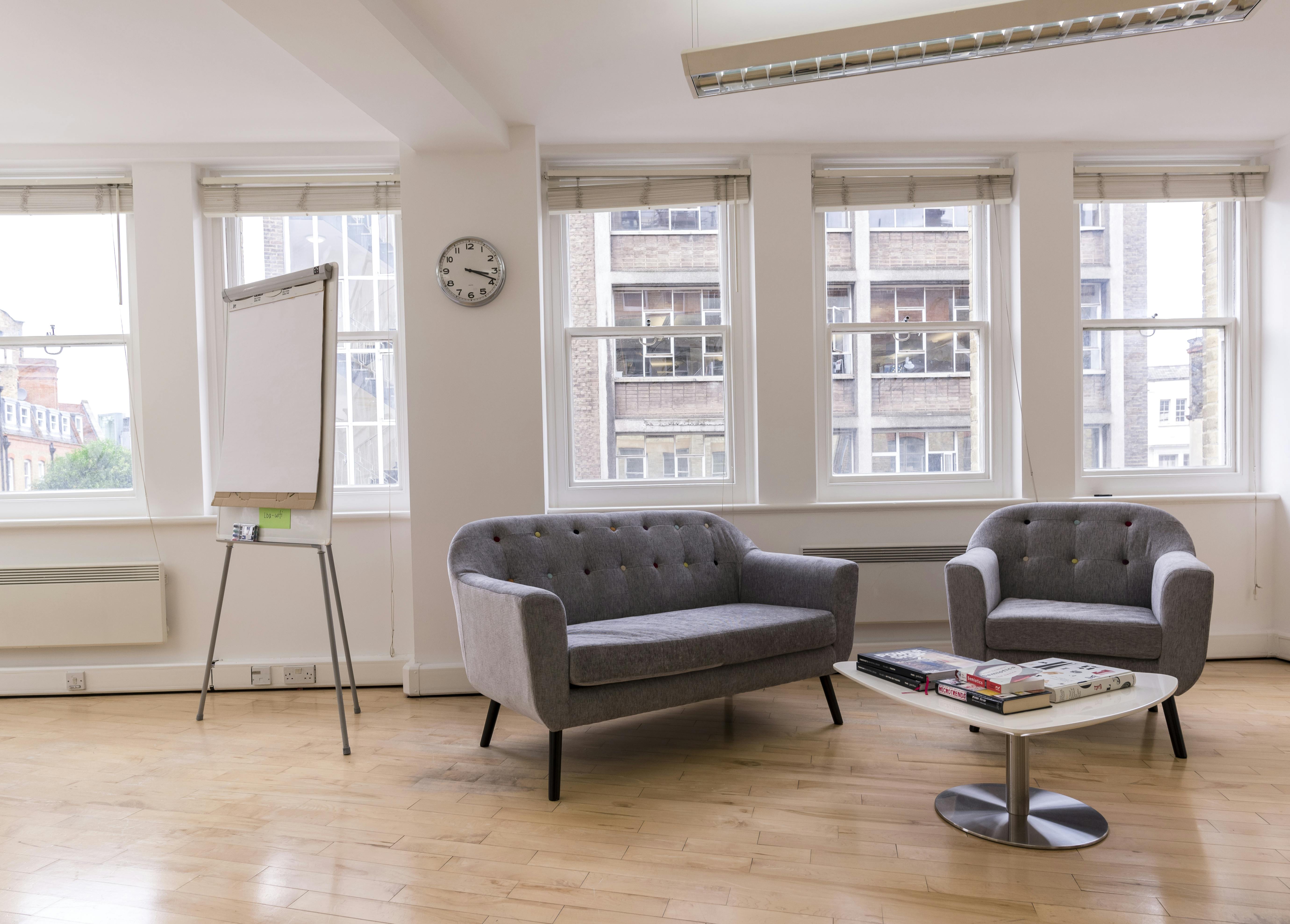 Bright modern meeting space with comfortable seating for workshops at Earls Court Community Hub.