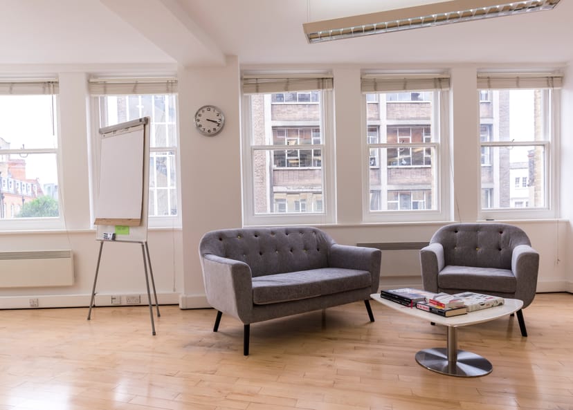 Bright modern meeting space with comfortable seating for workshops at Earls Court Community Hub.