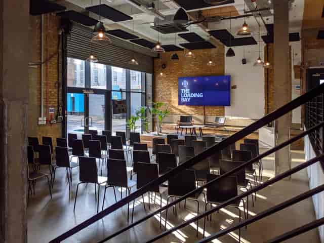Versatile event space with exposed brick, ideal for corporate meetings and workshops.
